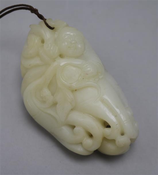 A Chinese white jade carving of a boy clambering on a finger citron, 7.7cm